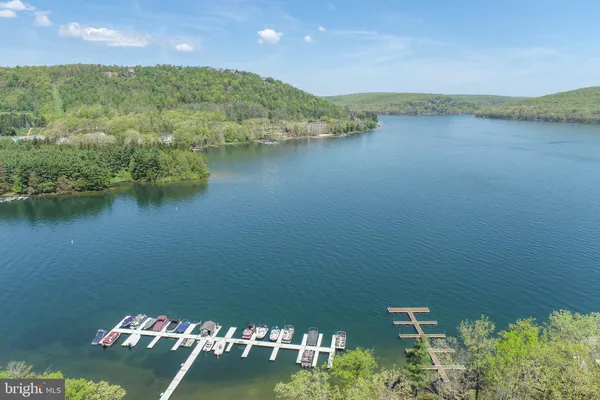 an aerial view of a house with a yard and lake view
