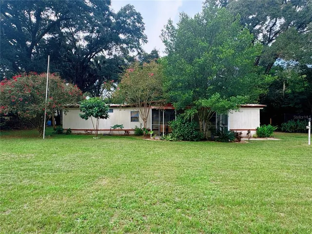 a front view of house with a garden