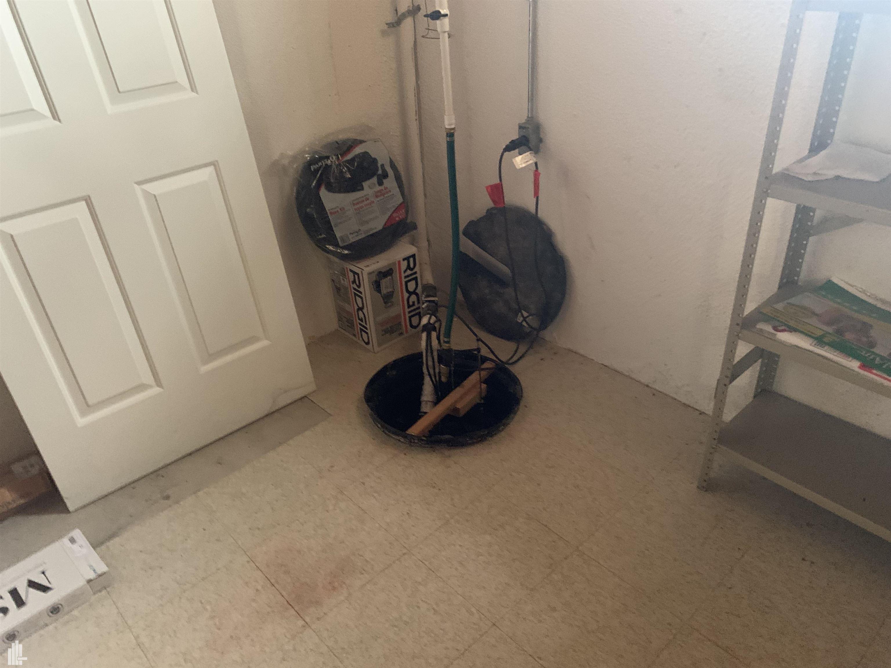 16740 Country Ridge Court Macomb, MI 48044 - Photo 26 of 30 Sump Pump in Basement