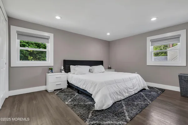 a bedroom with a large bed and a window