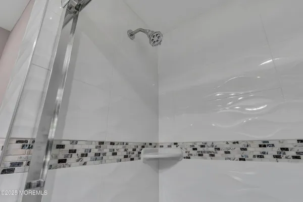 a bathroom with a shower and a window