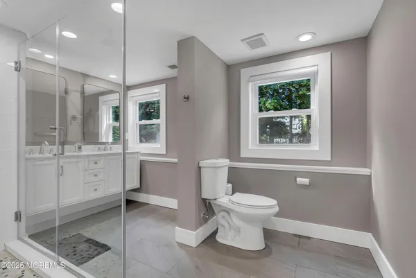 a bathroom with a toilet sink and shower