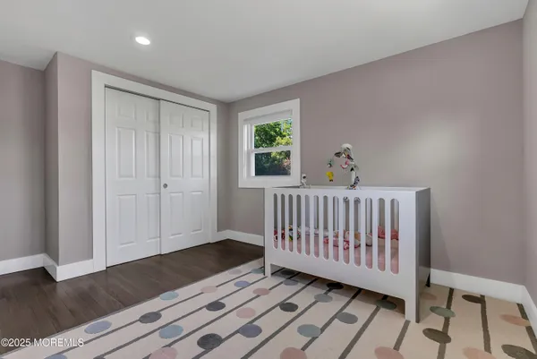 a view of a room with wooden floor & a window