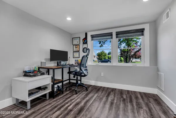 a view of a workspace with furniture and a window