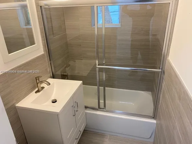a bathroom with a bathtub and a sink
