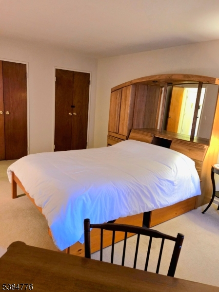 565 Grove Street, Unit C15 Clifton, NJ 07013 - Photo 11 of 11 a bed sitting in a bedroom next to a window