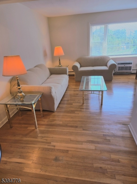 565 Grove Street, Unit C15 Clifton, NJ 07013 - Photo 6 of 11 a living room with furniture and a wooden floor