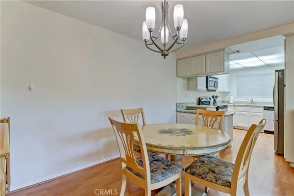 a view of a dining room with furniture and chandelier