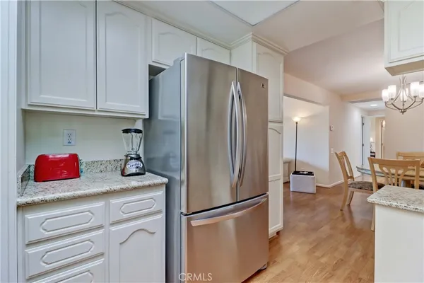 a kitchen with stainless steel appliances granite countertop a sink and cabinets
