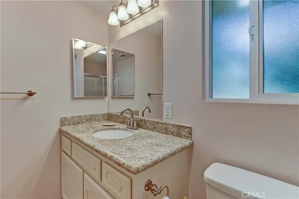 a bathroom with a glass shower door