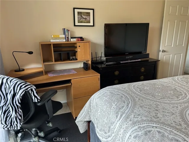 a bathroom with a granite countertop toilet a sink and mirror
