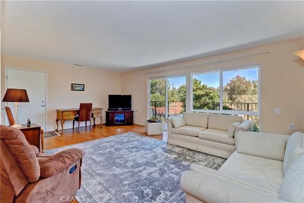 a living room with furniture and a large window