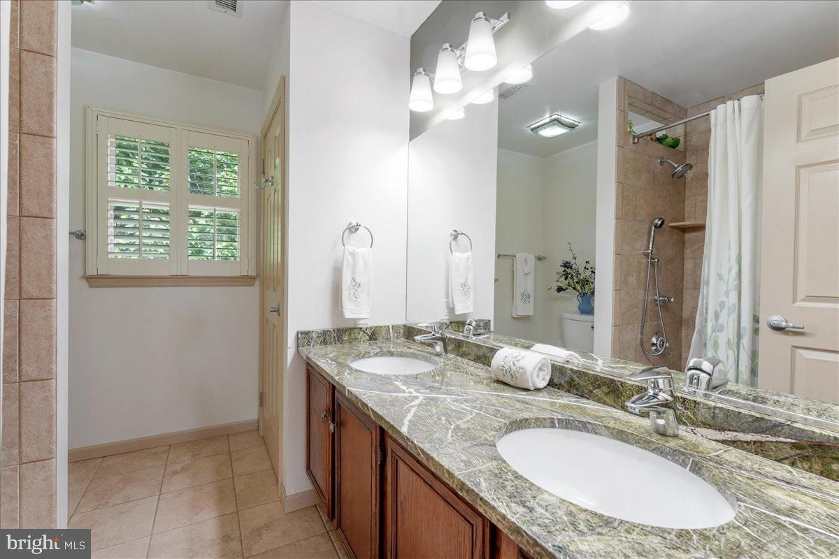 3303 Goodley Road Garnet Valley, PA 19060 - Photo 26 of 31 Updated Tiled Hall Bath With Double Vanity