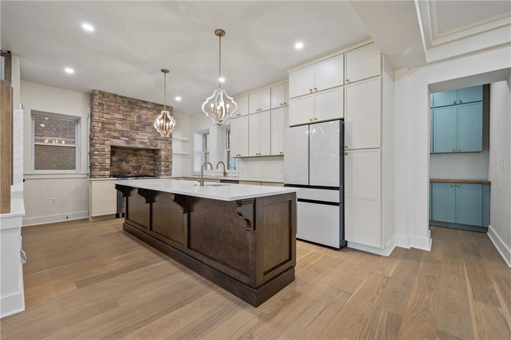 5563 Hampton Street Pittsburgh, PA 15206 - Photo 13 of 29 a kitchen with stainless steel appliances kitchen island wooden cabinets and granite counter tops