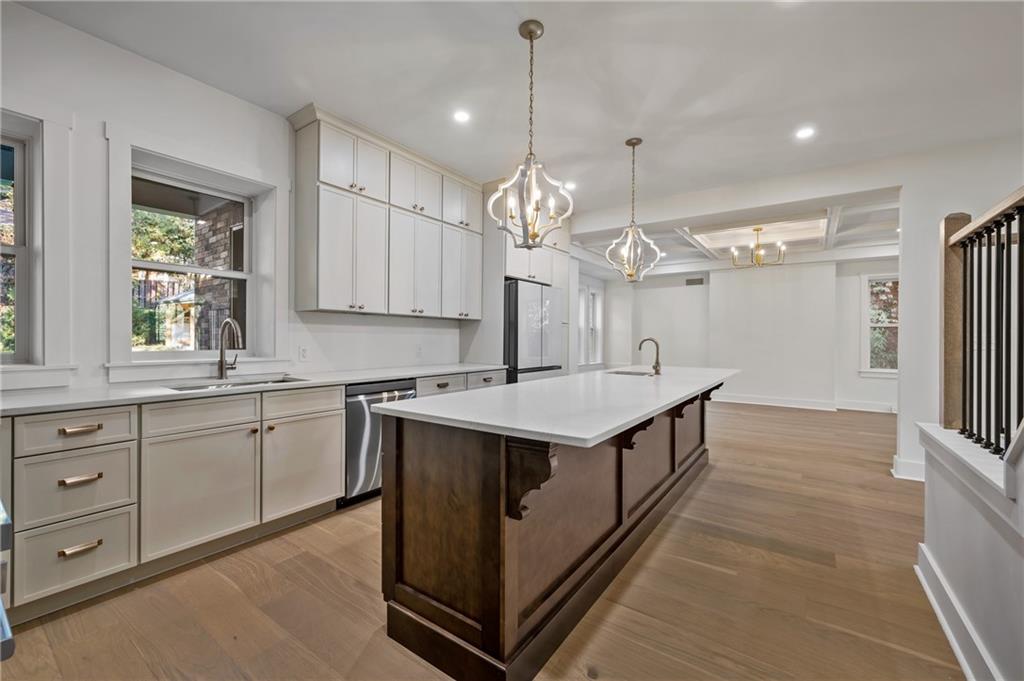 5563 Hampton Street Pittsburgh, PA 15206 - Photo 14 of 29 a kitchen with granite countertop a sink cabinets and window