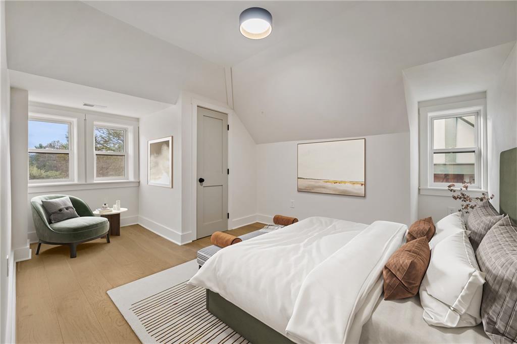 5563 Hampton Street Pittsburgh, PA 15206 - Photo 20 of 29 a bedroom with a bed and a couch