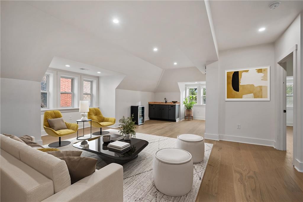5563 Hampton Street Pittsburgh, PA 15206 - Photo 22 of 29 a living room with furniture and a wooden floor