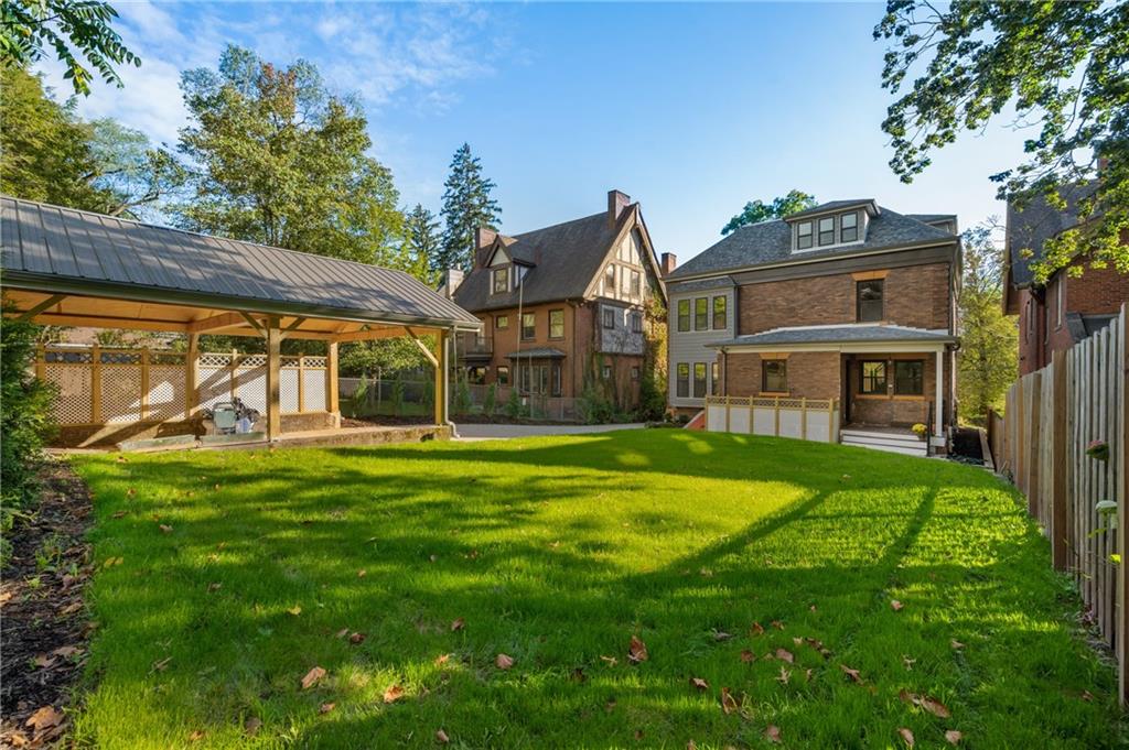 5563 Hampton Street Pittsburgh, PA 15206 - Photo 6 of 29 a front view of a house with a yard