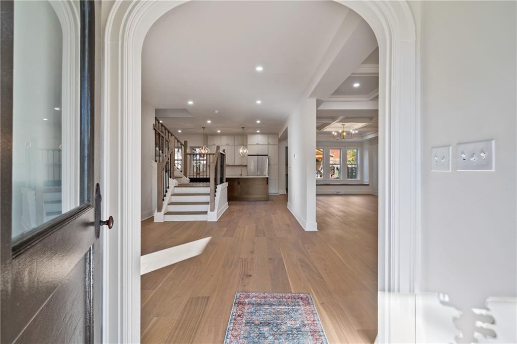 5563 Hampton Street Pittsburgh, PA 15206 - Photo 7 of 29 a view of a hallway with wooden floor kitchen and living room