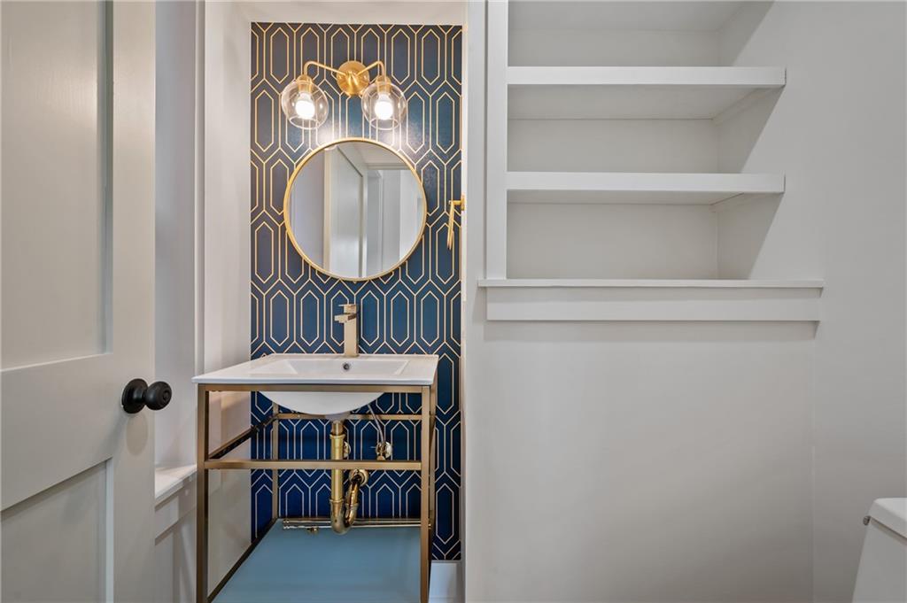 5563 Hampton Street Pittsburgh, PA 15206 - Photo 8 of 29 a bathroom with a sink and a mirror