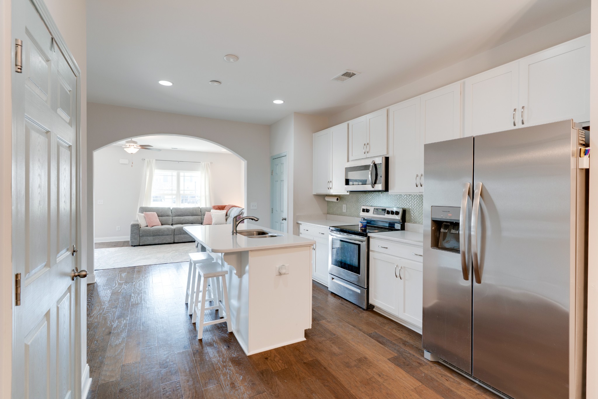 420 Longstone Road Gallatin, TN 37066 - Photo 7 of 24 a kitchen with stainless steel appliances granite countertop a refrigerator a stove and a sink with wooden floor