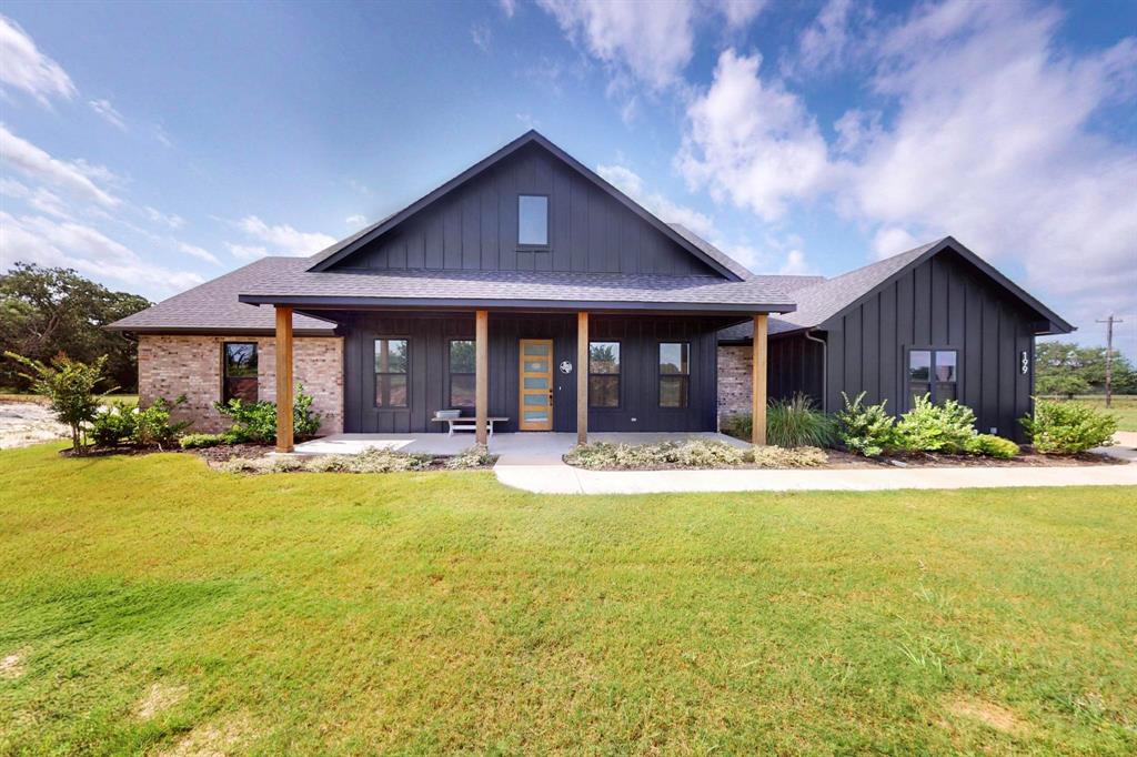 a view of a house with swimming pool and a large tree