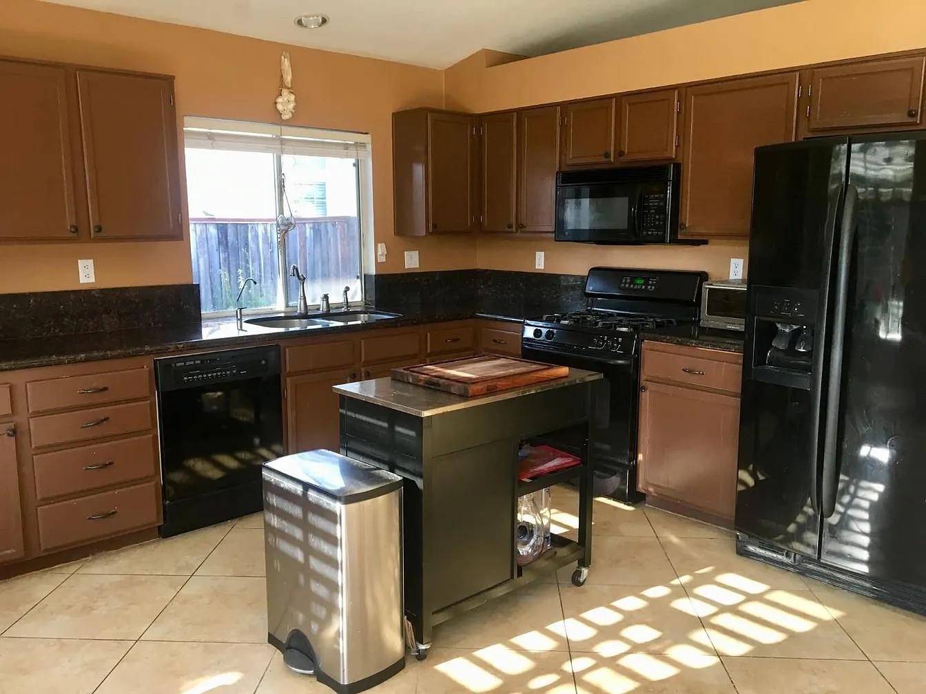 830 Capitola Drive Hollister, CA 95023 - Photo 12 of 14 a kitchen with a stove a refrigerator and cabinets