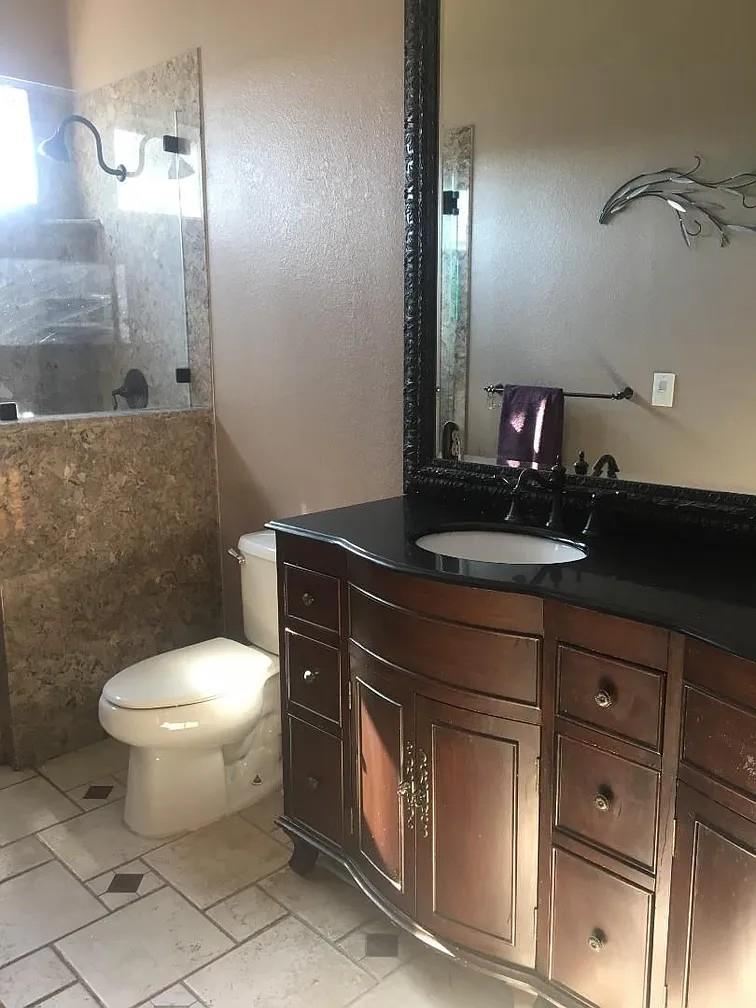 830 Capitola Drive Hollister, CA 95023 - Photo 14 of 14 a bathroom with a toilet sink and mirror