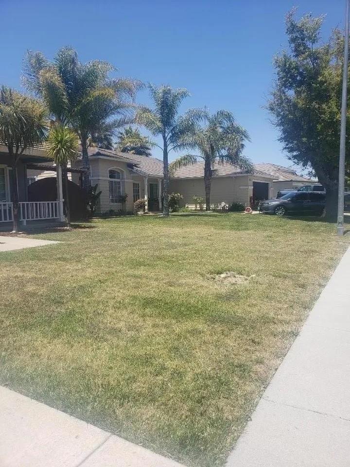 830 Capitola Drive Hollister, CA 95023 - Photo 4 of 14 a couple of flower plants in front of house