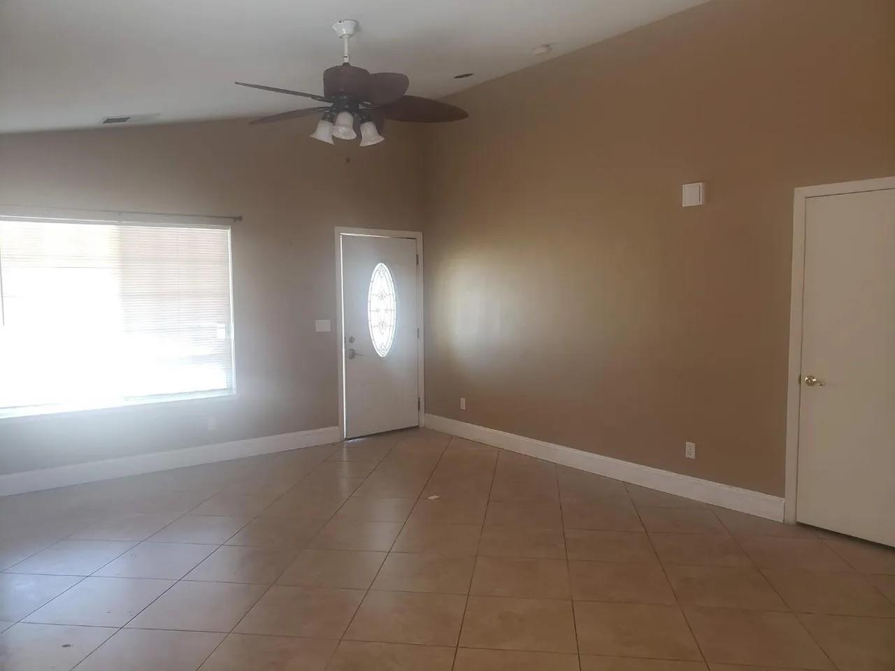830 Capitola Drive Hollister, CA 95023 - Photo 9 of 14 an empty room with a window and a fan