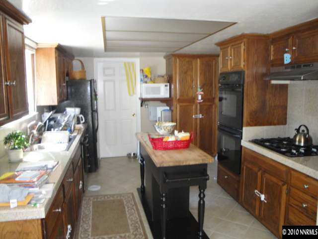 11000 Raintree Court Reno, NV 89511 - Photo 2 of 13 a kitchen with a sink stove and refrigerator