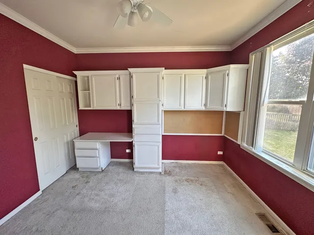 a bedroom with a bed and glass window