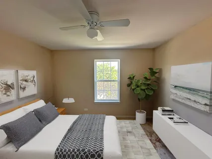 an empty room with a window and a ceiling fan