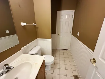 a bathroom with a tub sink and mirror