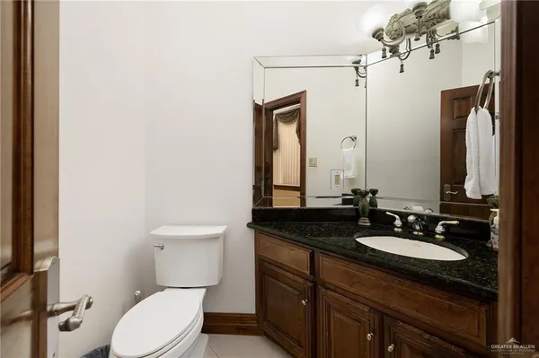 a bathroom with a toilet a sink and shower