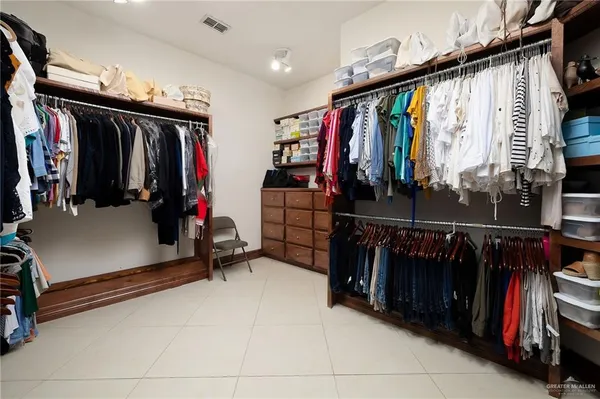 a large kitchen with a sink and cabinets