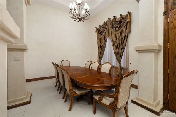 a dining room with furniture and chandelier