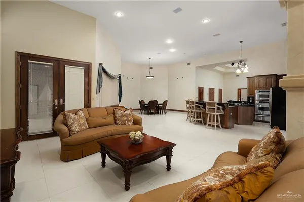 a living room with furniture and kitchen view