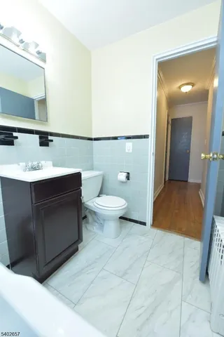 a bathroom with a sink a toilet and mirror