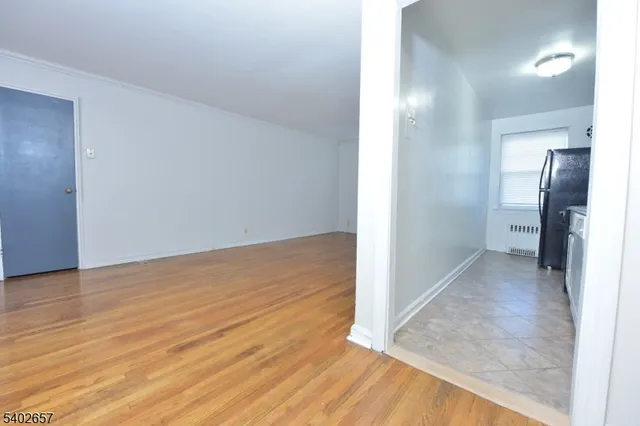 wooden floor in a hall with an empty room