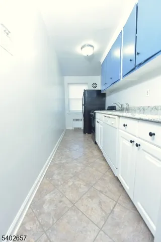 a kitchen with granite countertop a sink and cabinets