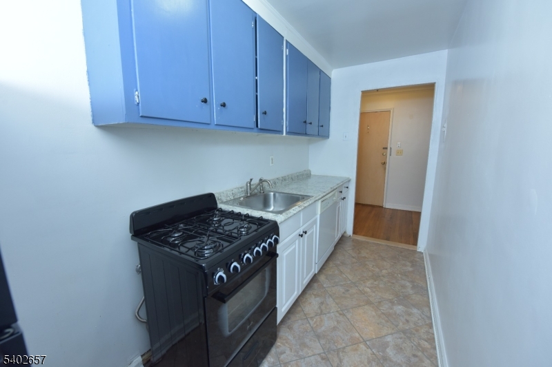 44 Union Street, Unit 6 Montclair, NJ 07042 - Photo 8 of 12 a kitchen that has a sink stove and cabinets