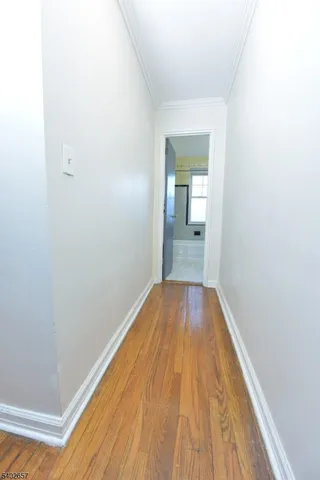 a view of a room with wooden floor and bench
