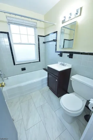 a bathroom with a sink toilet and mirror
