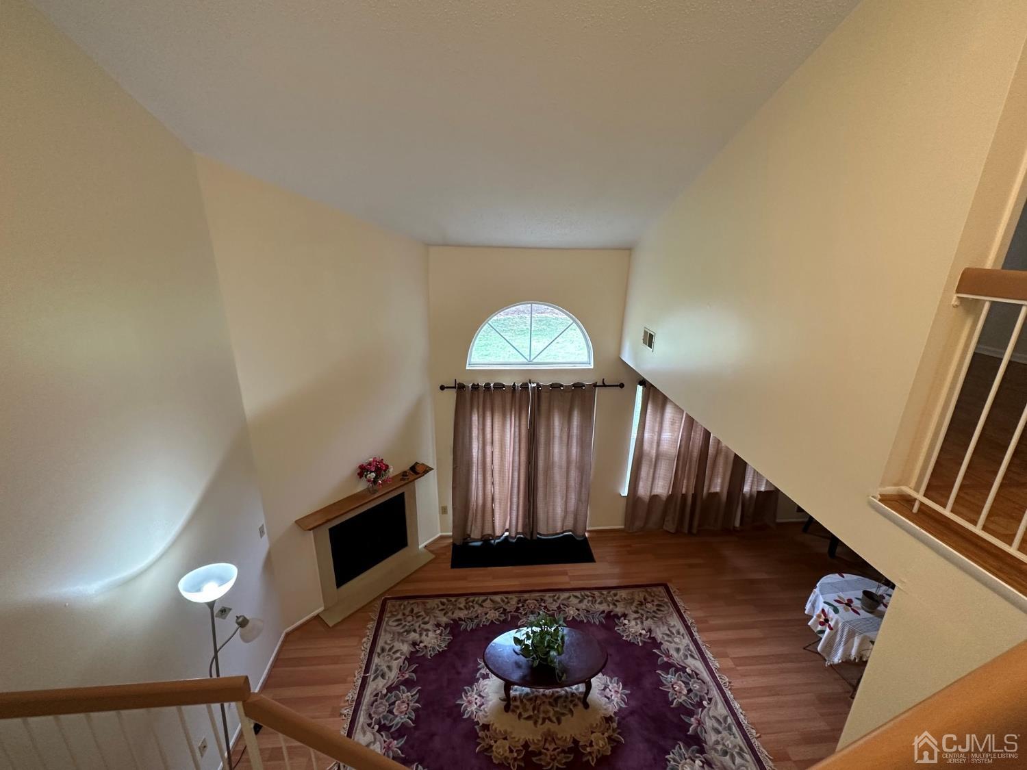 260 Nebula Road Piscataway, NJ 08854 - Photo 14 of 46 a view of a livingroom with wooden floor and a fireplace