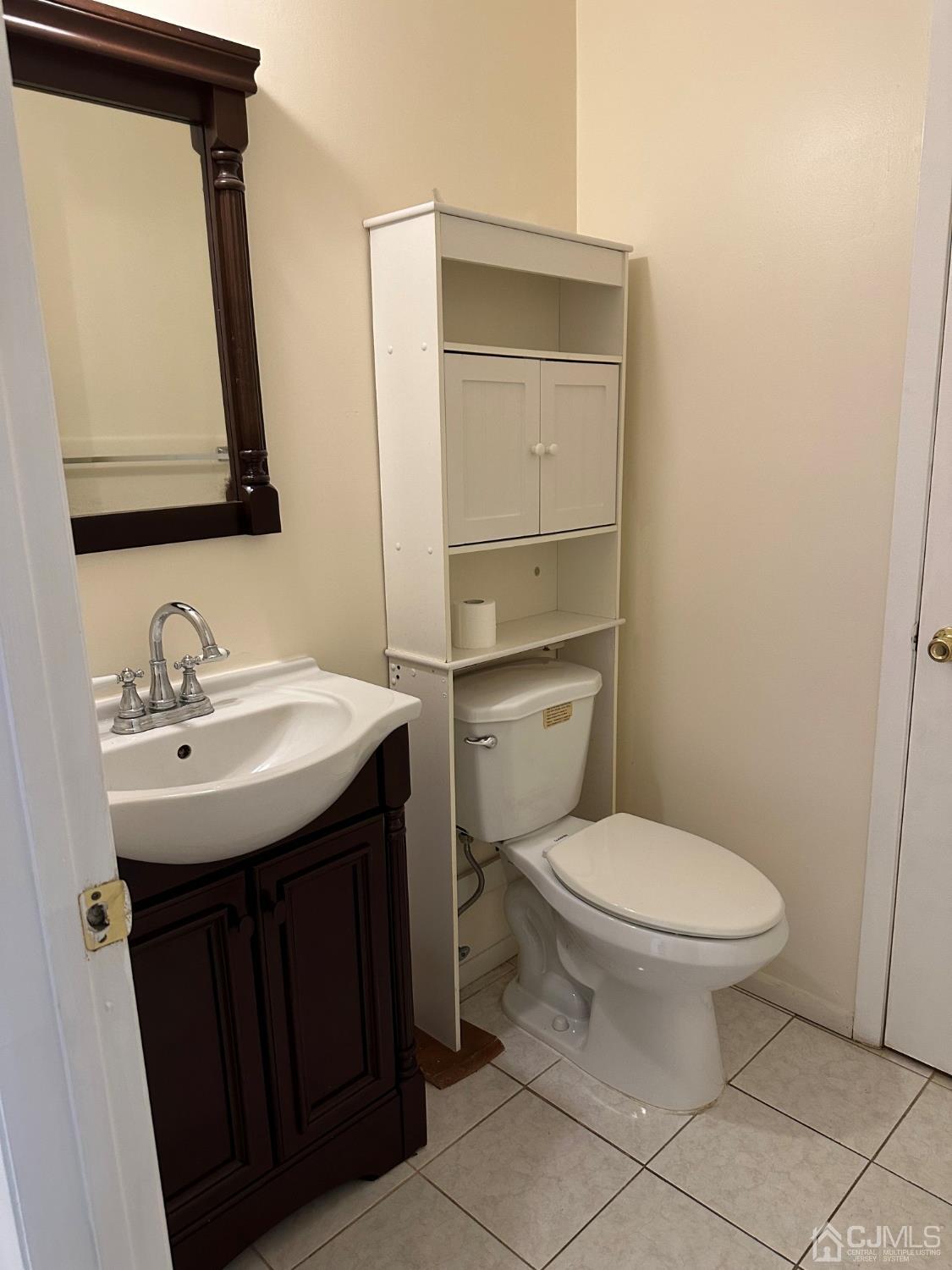 260 Nebula Road Piscataway, NJ 08854 - Photo 22 of 46 a bathroom with a toilet sink and mirror