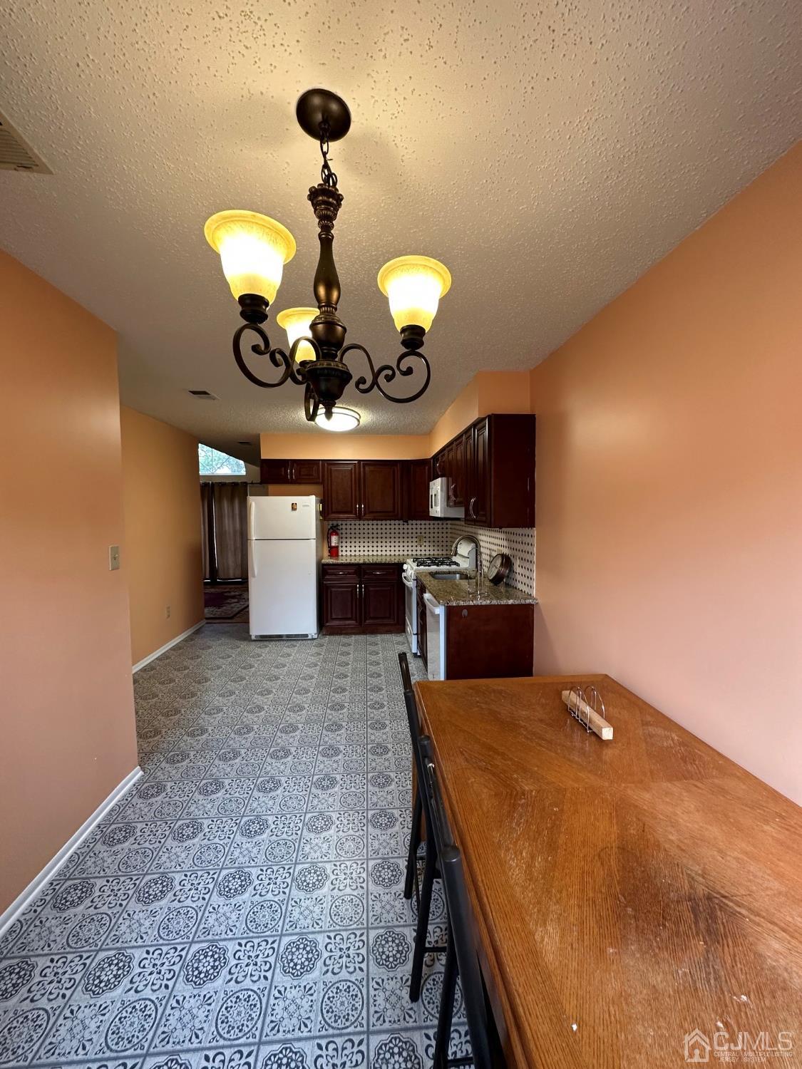260 Nebula Road Piscataway, NJ 08854 - Photo 29 of 46 a kitchen with stainless steel appliances granite countertop a sink a stove and a refrigerator