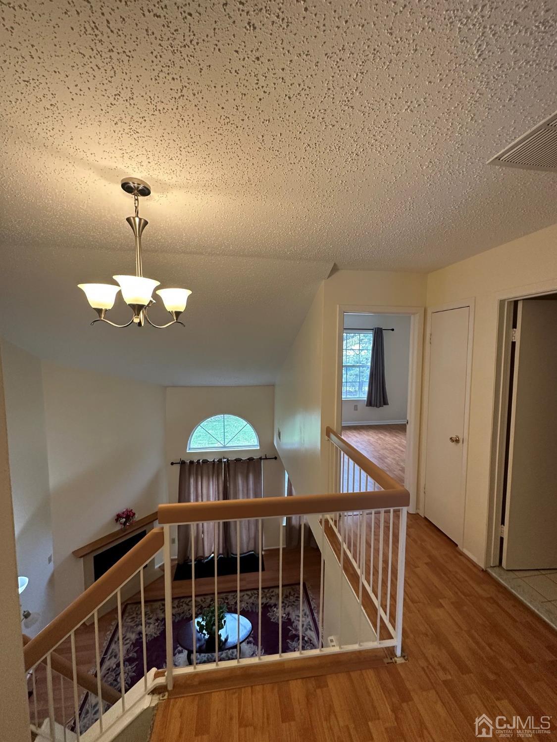 260 Nebula Road Piscataway, NJ 08854 - Photo 30 of 46 a view of a livingroom with wooden floor and a ceiling fan