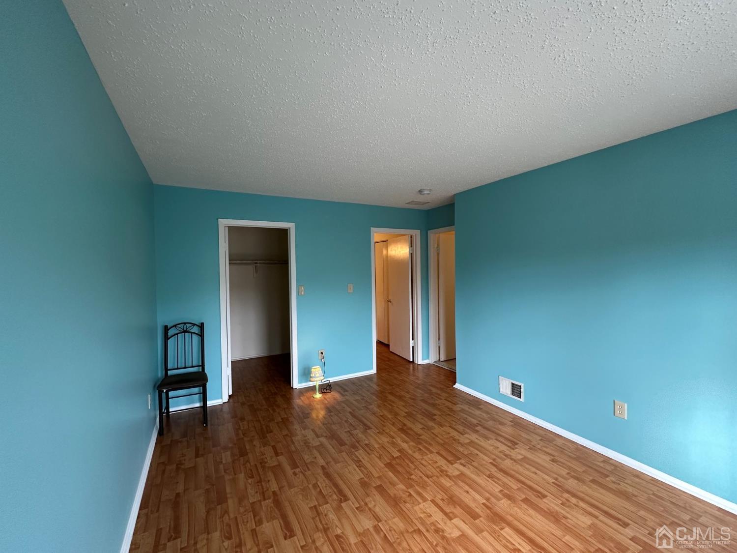260 Nebula Road Piscataway, NJ 08854 - Photo 32 of 46 a view of an empty room with wooden floor and closet