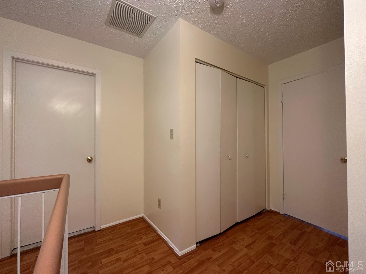 260 Nebula Road Piscataway, NJ 08854 - Photo 33 of 46 a view of an empty room with wooden floor